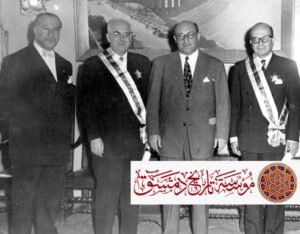 مع الرئيس صبري العسلي يوم تقليد الدكتور قسطنطين زريق وسام الاستحقاق السوري سنة 1956. امن اليمين: نائب رئيس الجامعة الأميركية في بيروت فؤاد صروف، الرئيس صبري العسلي، الدكتور زريق، القاضي حنا مالك.